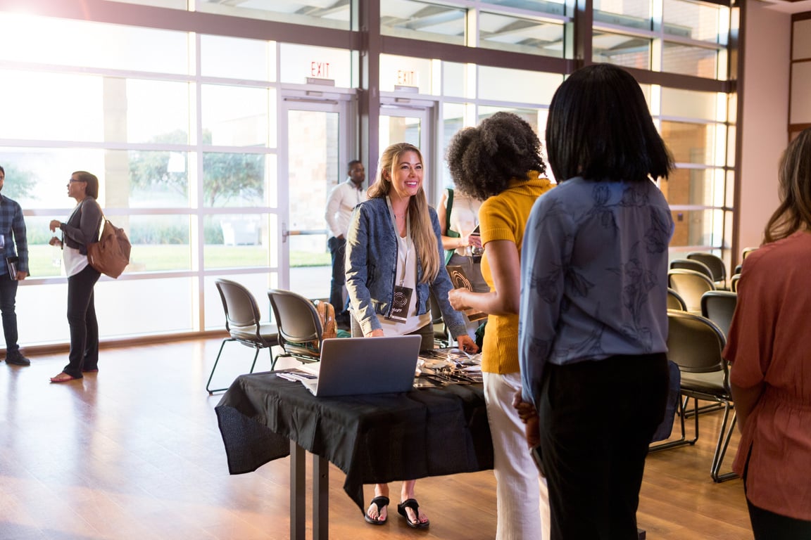 Mid adult woman cheerfully handles expo registration