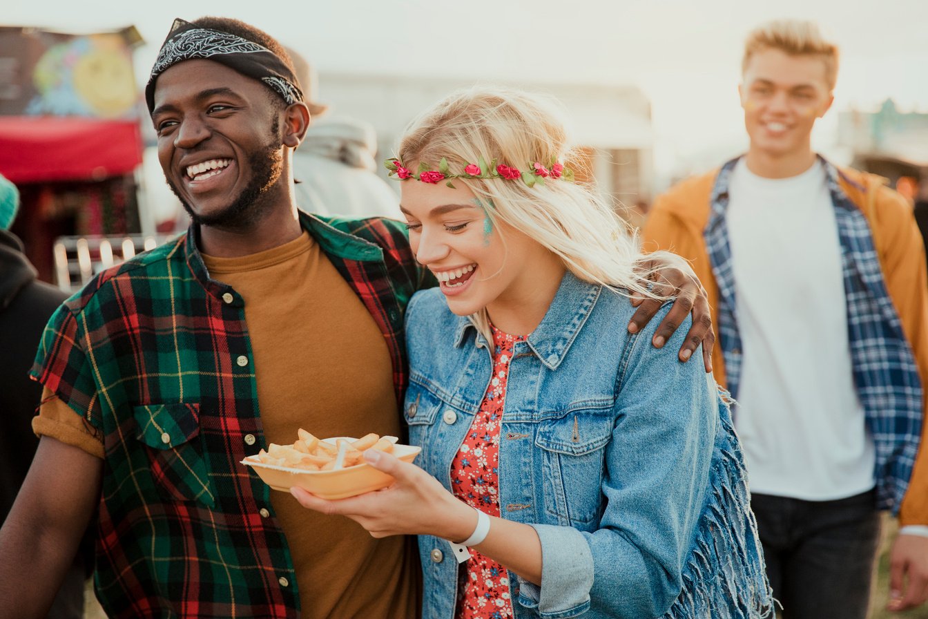 Friends Eating Food at a Festival